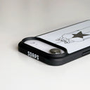 A close-up of a black phone case with a white back panel featuring a minimalist line drawing of girls and a star, with the brand name 'SOAPS' printed in white on the black bumper edge.
